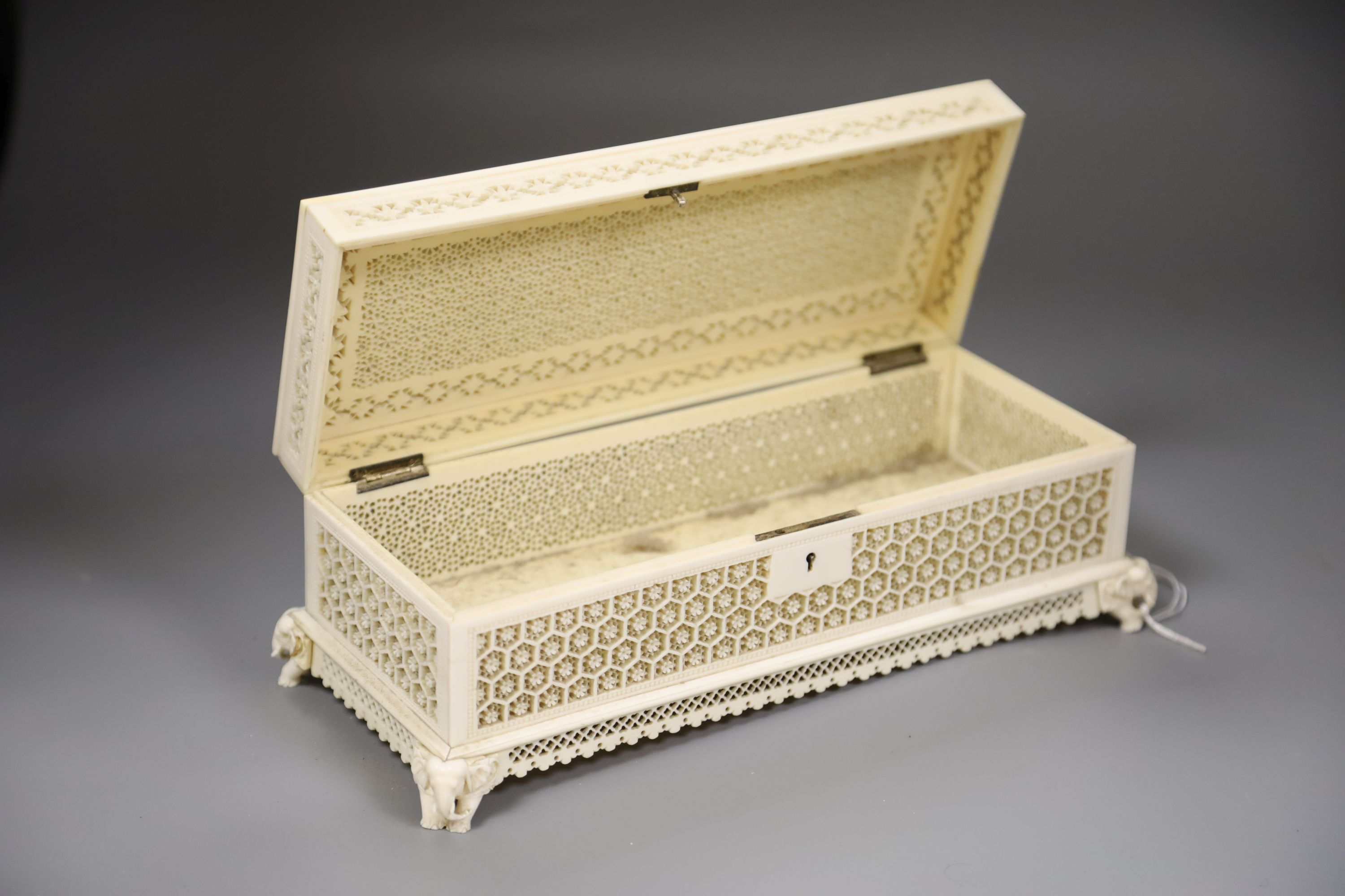 An antique Indian carved ivory casket, length 29cm (no key)